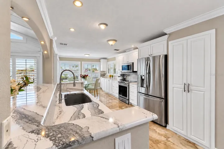 Kitchen with stone counters and stainless steel appliances.