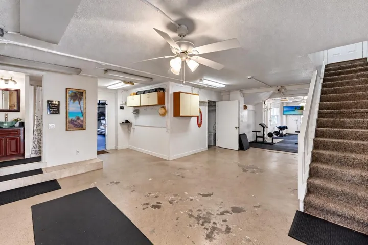 Ground-level garage and workshop area. Virtually staged – personal items digitally removed.