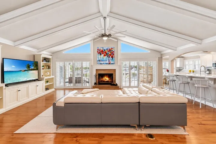 Great room with vaulted ceiling, wood-burning fireplace and built-ins.