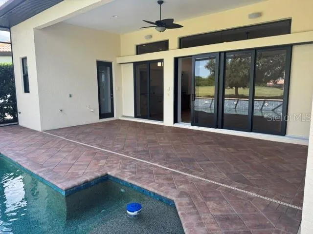 Undercover area,showing door into Powder Room /Pool bath