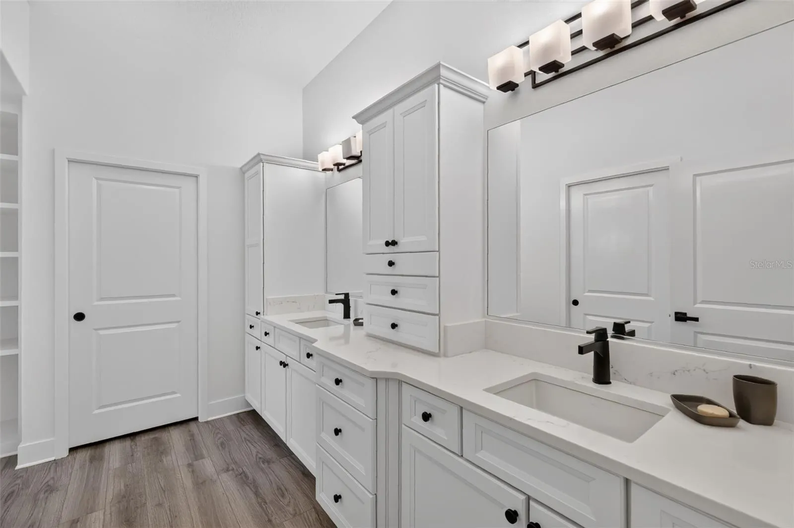 Primary bath with dual sinks and door to the water closet