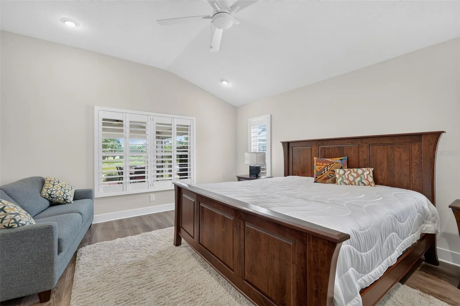 Primary bedroom - view of the pond and vaulted ceiling