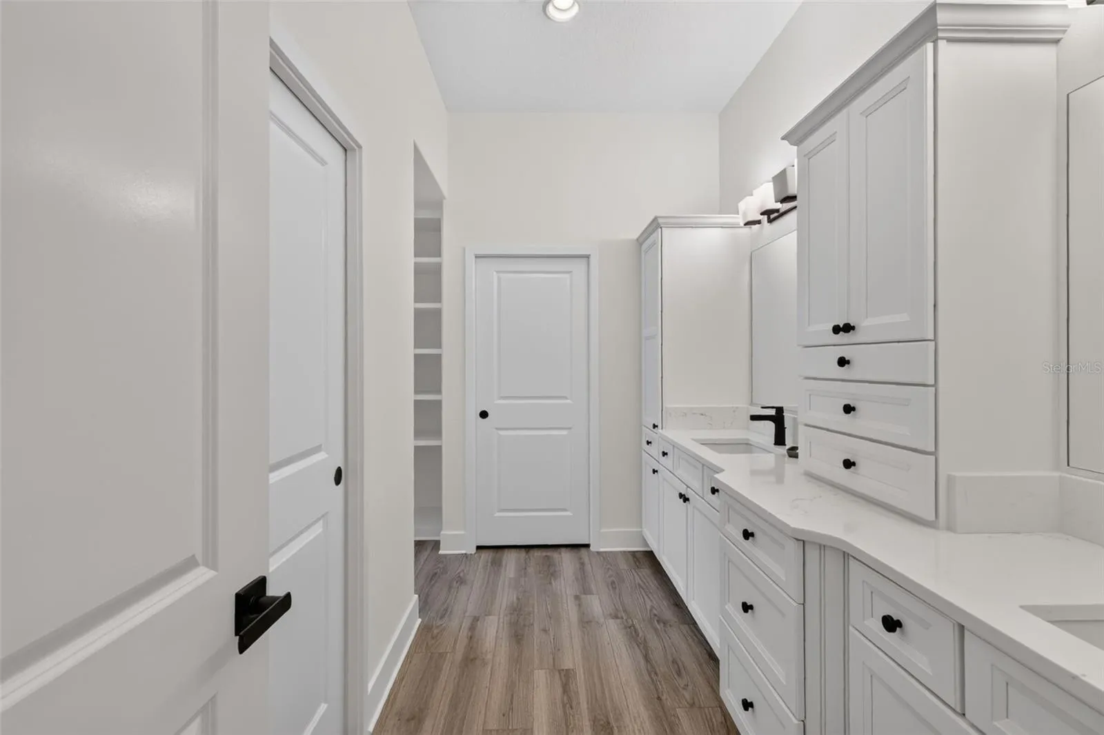 Primary en-suite bath with dual sinks and extra cabinets
