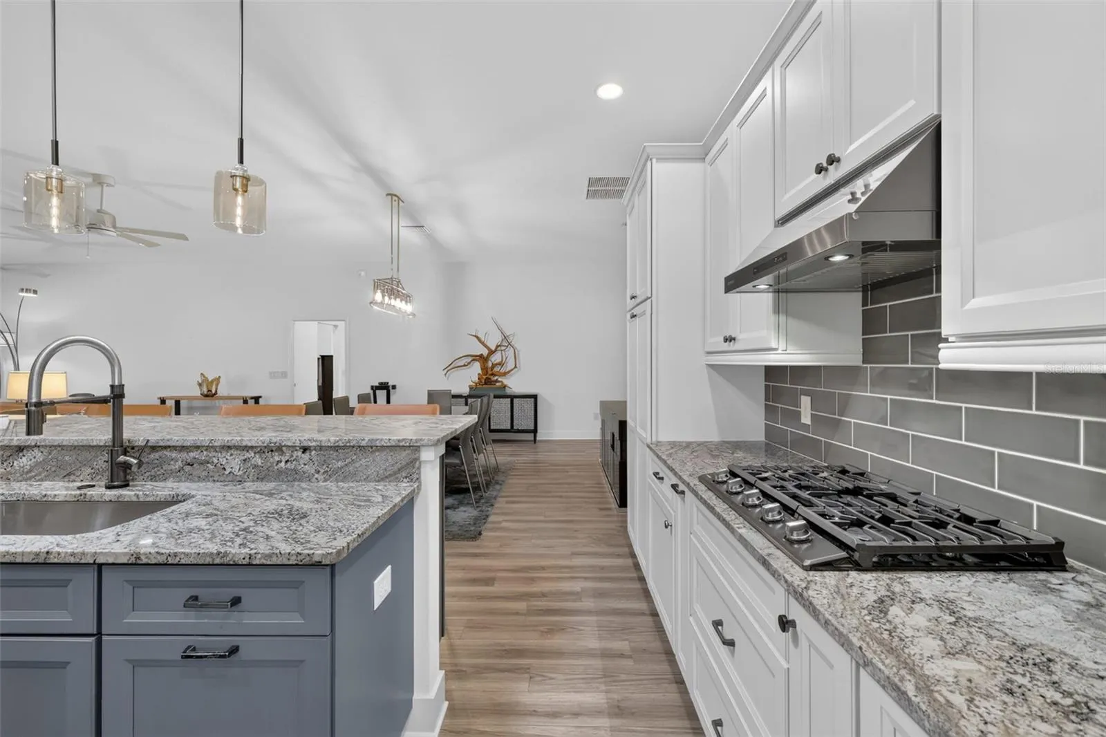 Kitchen with gas stove and tile backsplash