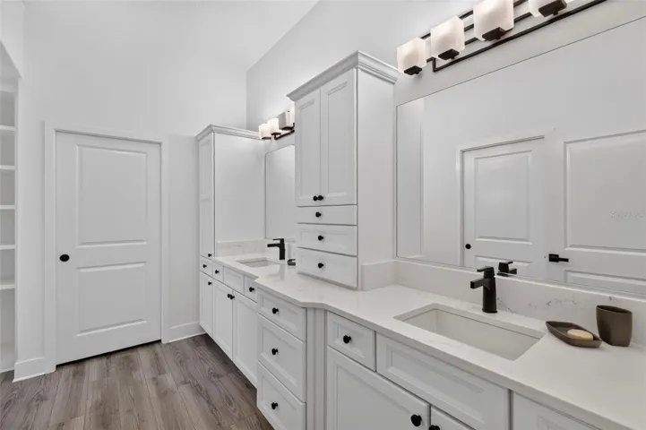 Primary bath with dual sinks and door to the water closet
