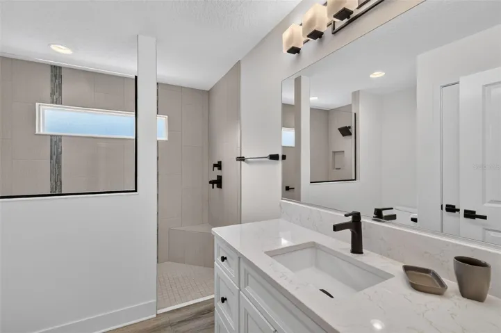 Back bathroom with walk-in tile shower