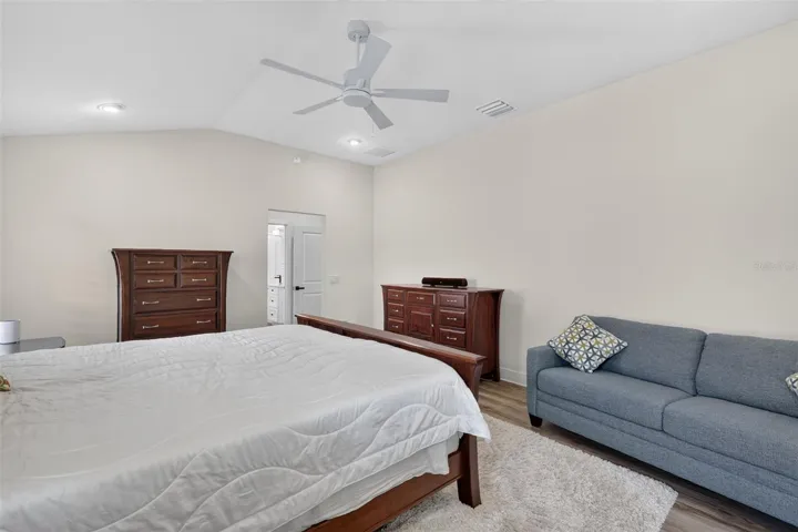 Primary bedroom with view to the walk-in closet and en-suite bath
