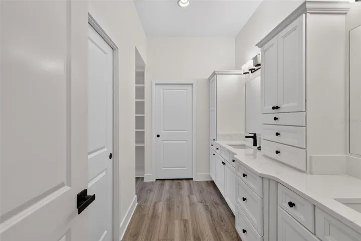 Primary en-suite bath with dual sinks and extra cabinets