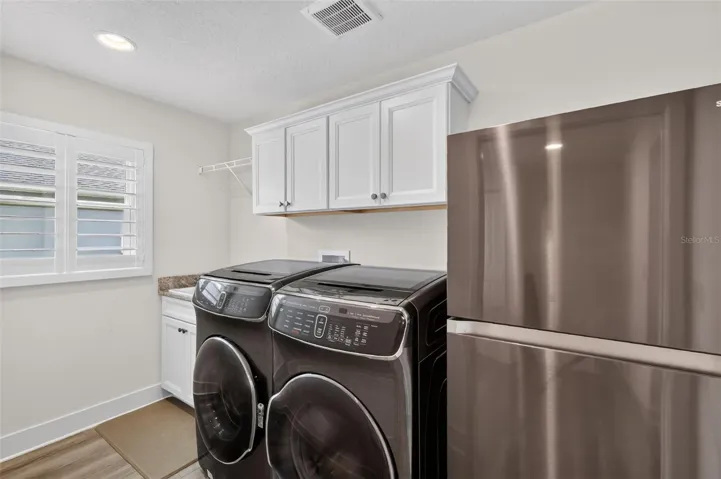 Laundry with utility sink and refrigerator
