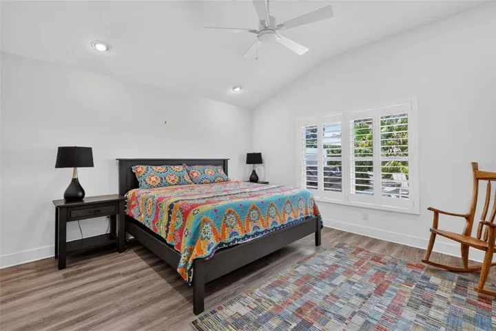 Back bedroom with high ceiling and view of the pond