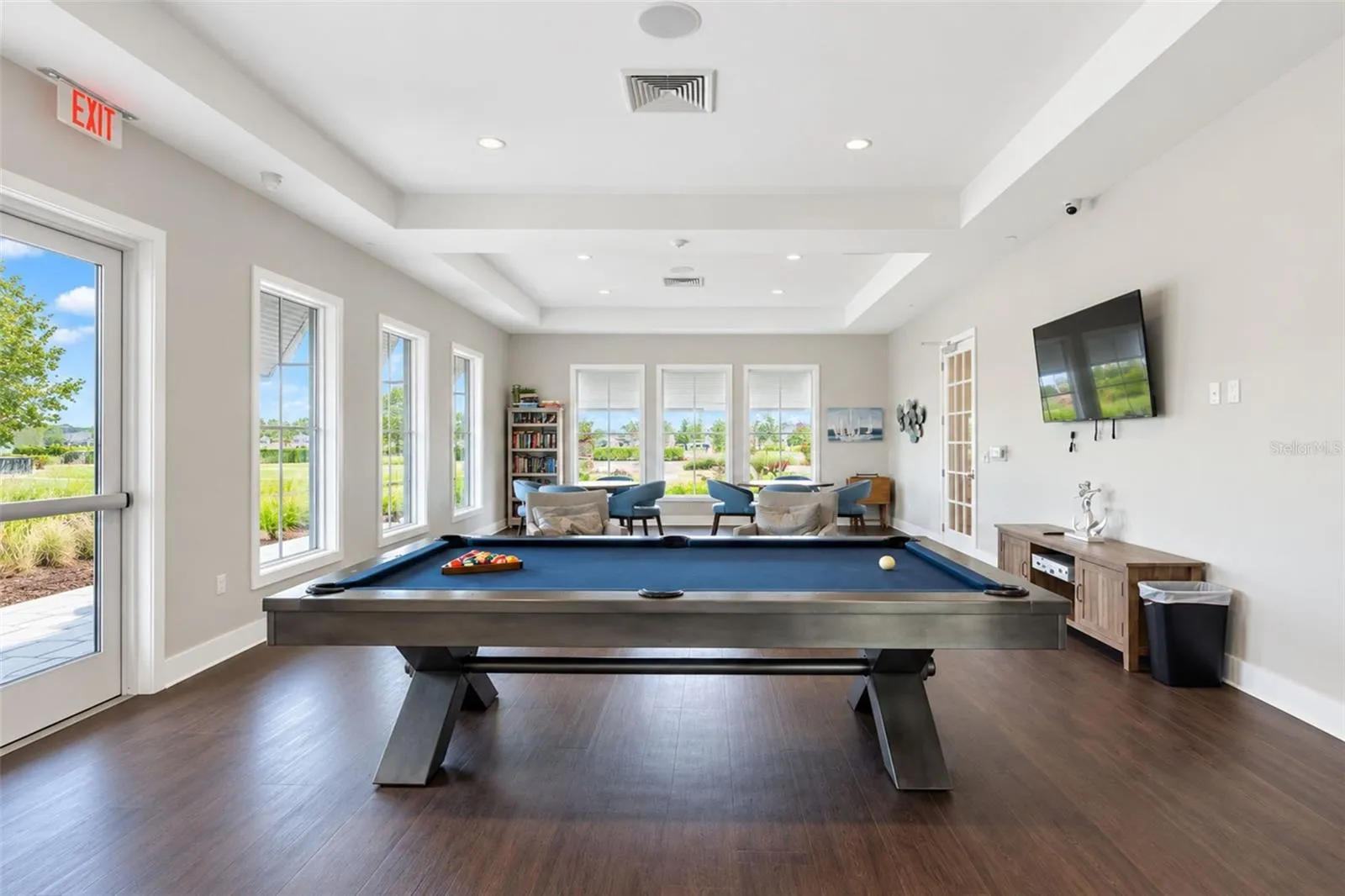 Inviting clubhouse game room featuring a pool table and comfortable gathering areas where residents come together for games, activities and social events.
