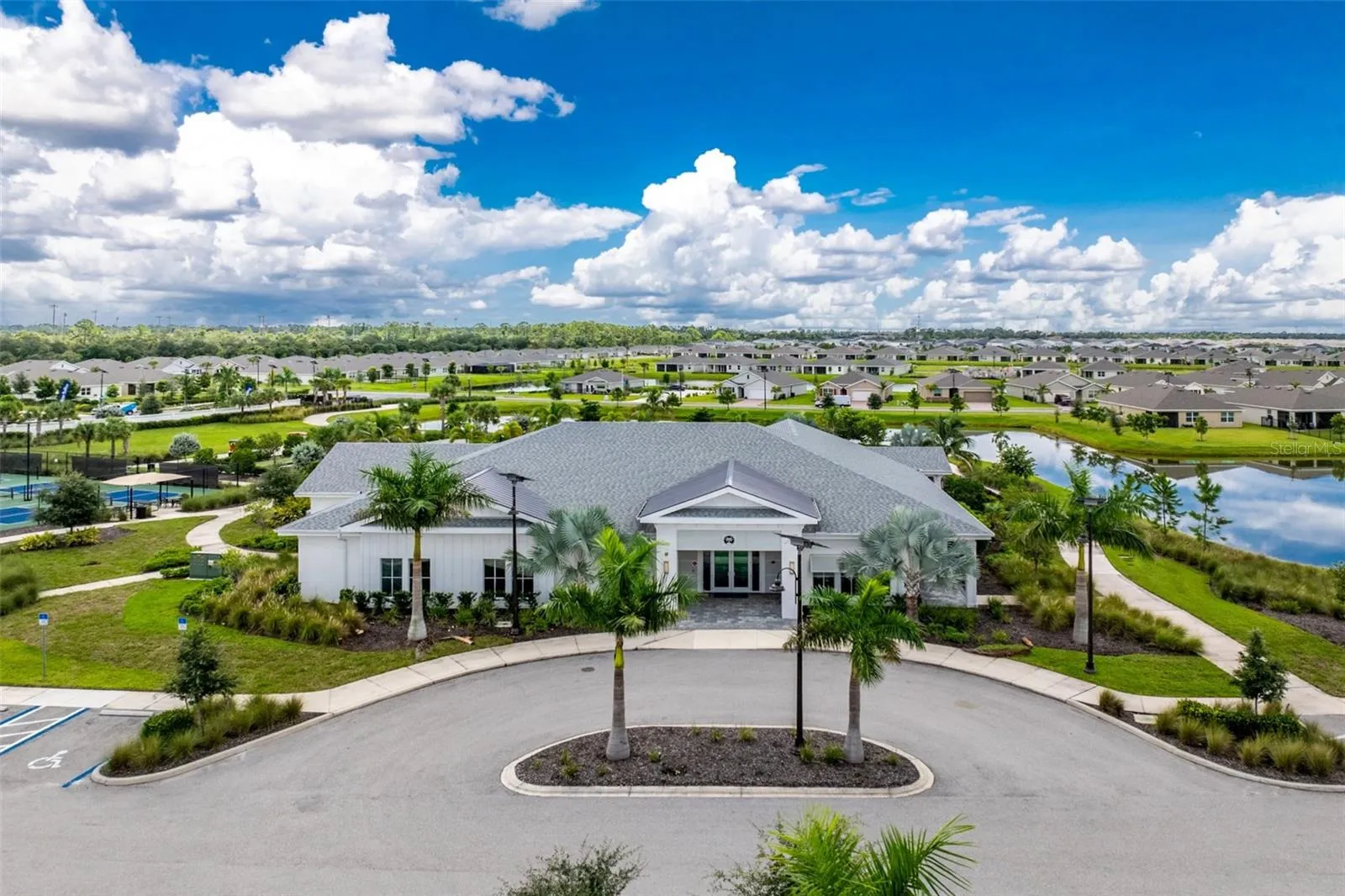 Beautiful community clubhouse featuring inviting gathering spaces, game room and fitness center, with convenient access leading directly to the resort-style pool and outdoor amenities.