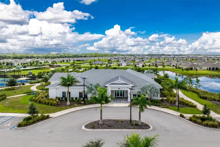Beautiful community clubhouse featuring inviting gathering spaces, game room and fitness center, with convenient access leading directly to the resort-style pool and outdoor amenities.