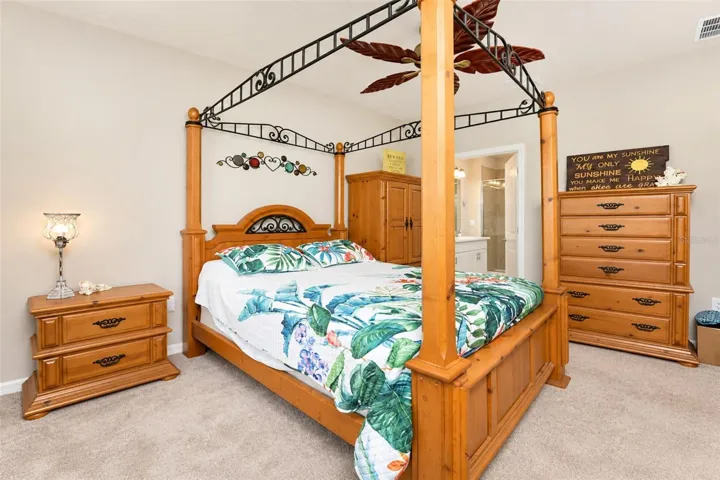 Comfortable primary suite with abundant natural light, ceiling fan.
