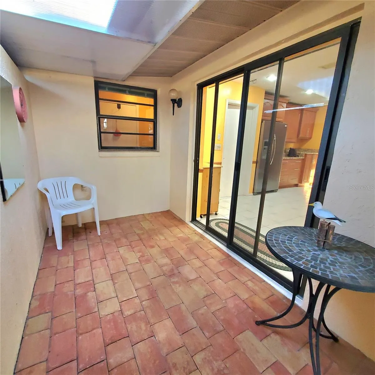 just off the kitchen dining area is an outdoor sitting area