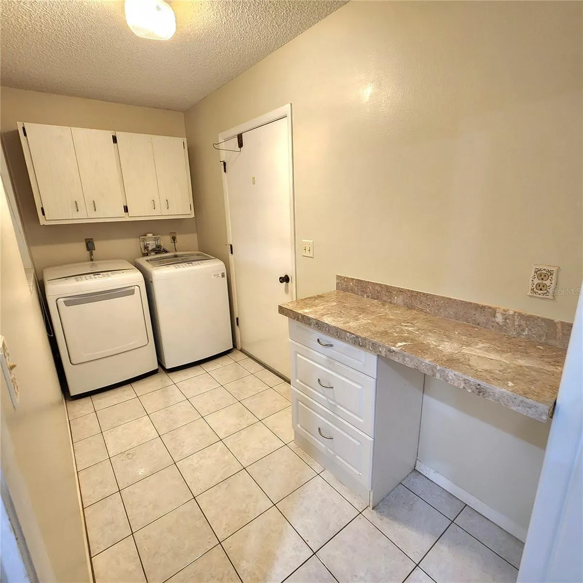 Laundry room with cabinets and desk