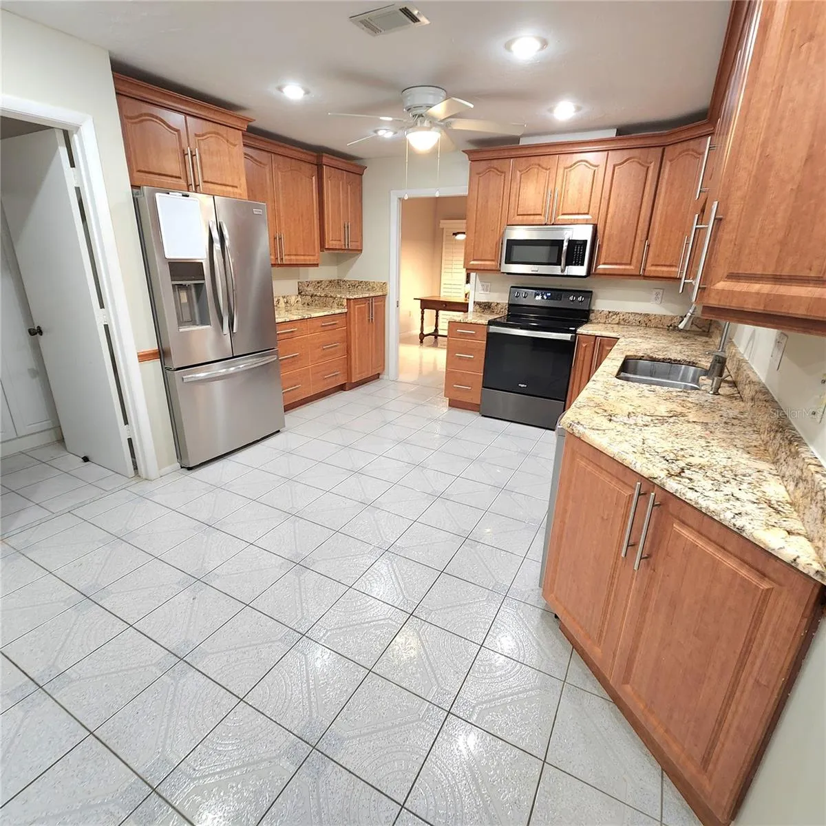 large spacious kitchen with plenty of counter space and cabinetry.