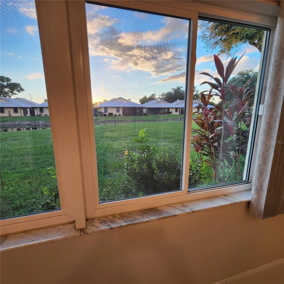 view of back yard from Bonus room Impact Windows