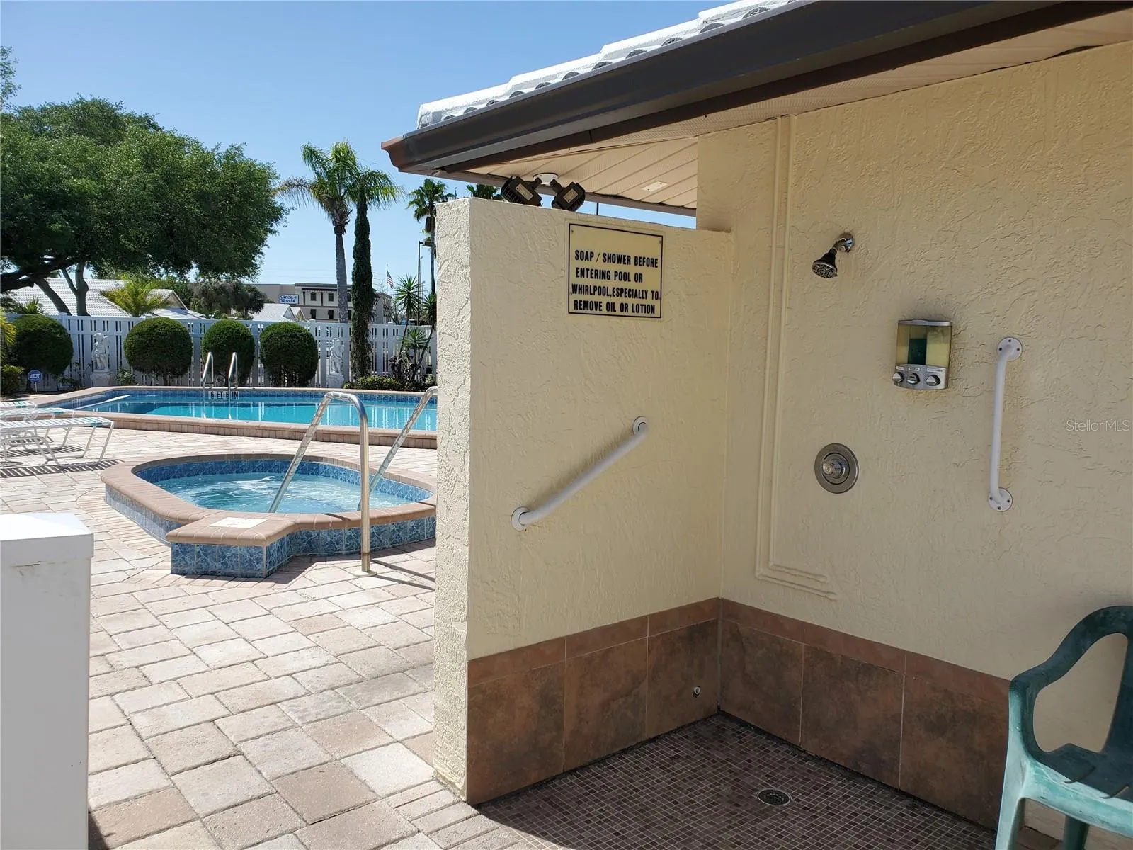 shower area at pool complete with soap, shampoo, conditioner