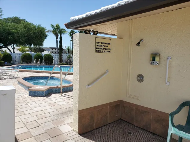 shower area at pool complete with soap, shampoo, conditioner