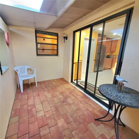 just off the kitchen dining area is an outdoor sitting area