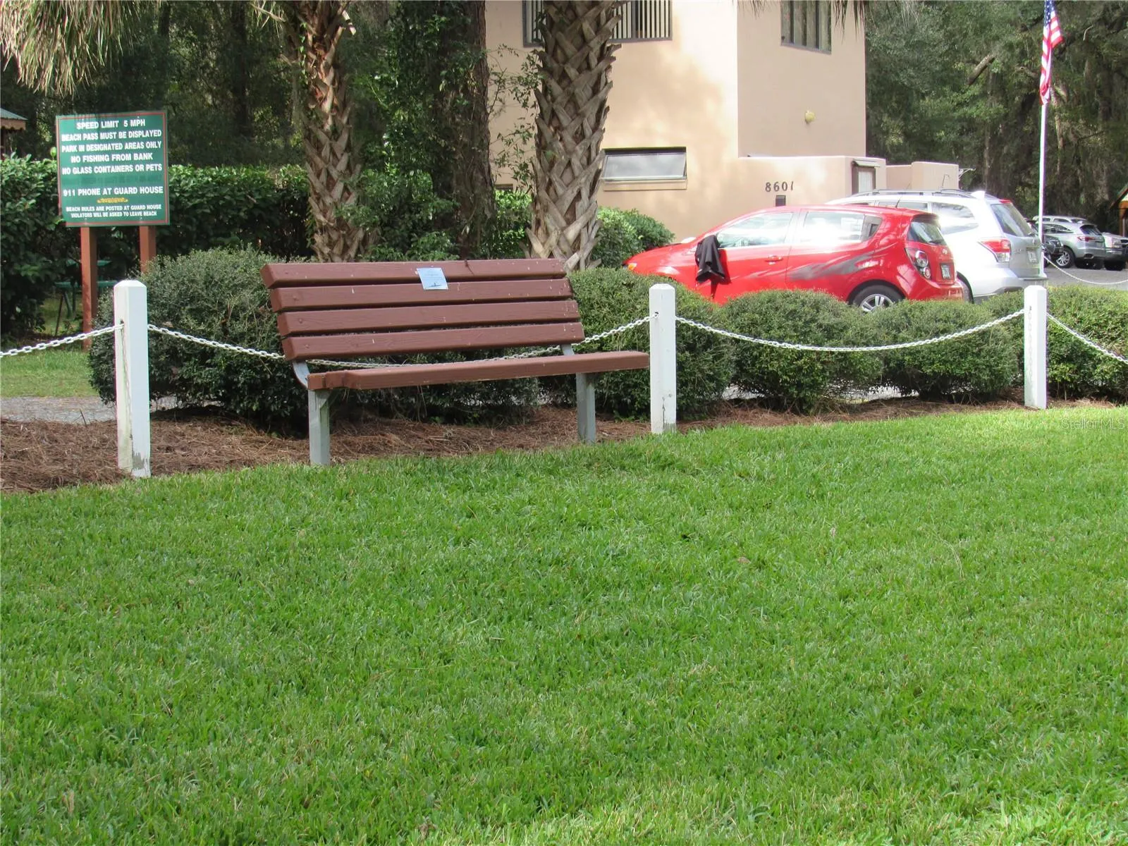 memory bench in grassy area overlooking swim area at River Park