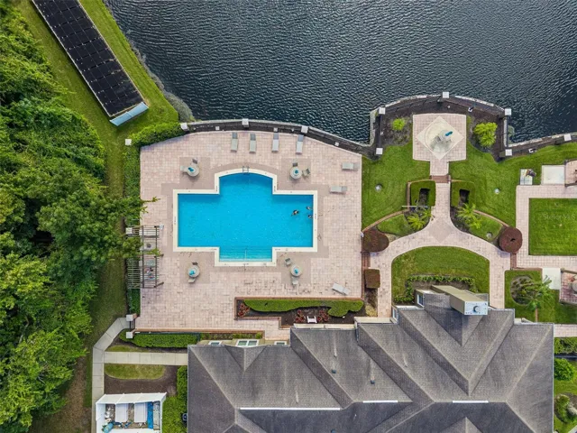 Overhead aerial view of the Sabal Point pool and clubhouse with the lake and shoreline to the north.