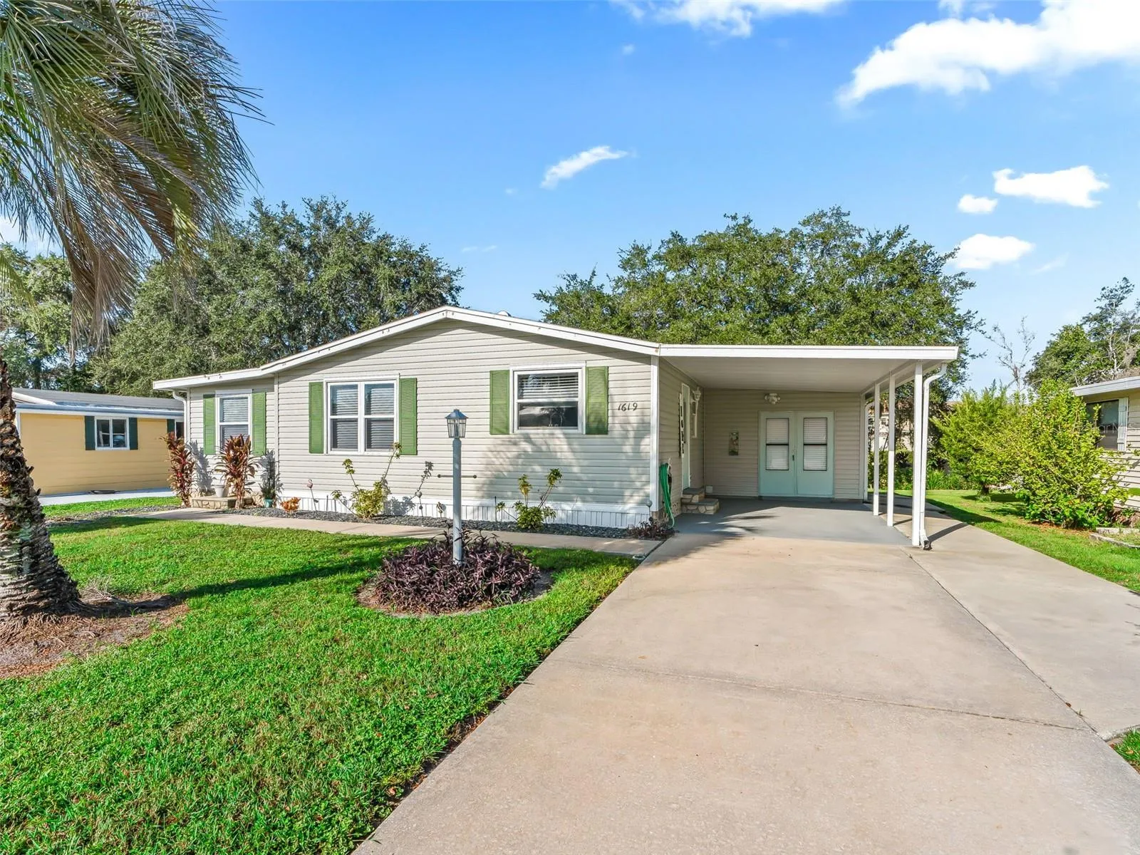 FRONT EXTERIOR - 1619 W Schwartz Blvd in the Village of Country Club. This UPDATED manufactured home with 1300 sf of living area has 2BR/2 BA/1 Carport + GOLF CART GARAGE in rear of home.
