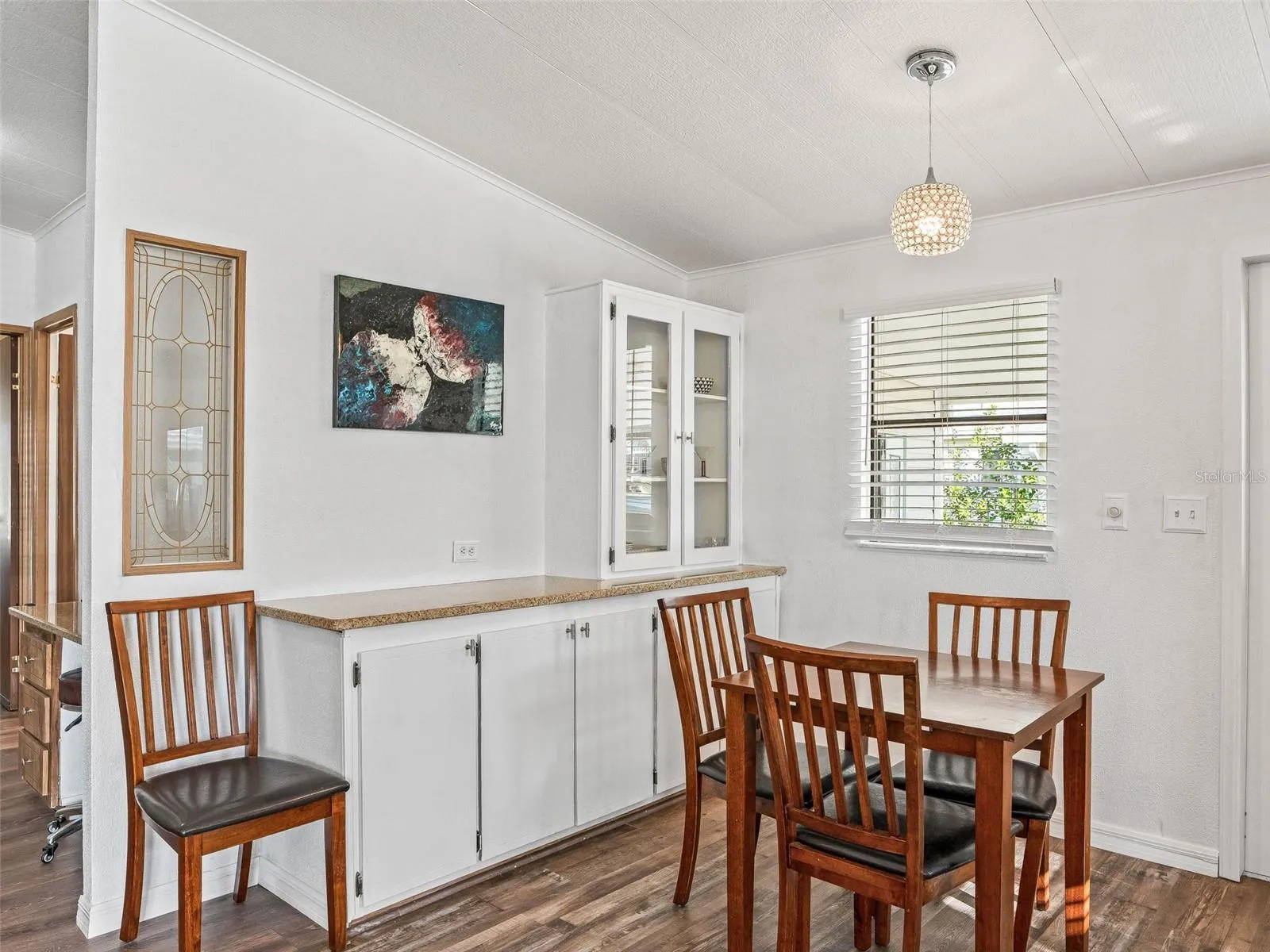 View of DINING ROOM - HALLWAY to Bedrooms (far L), Built-in BUFFET &amp; small CHINA HUTCH w/ matching GRANITE COUNTERTOP (Center), and FRONT DOOR ENTRANCE (partially visible on far R).