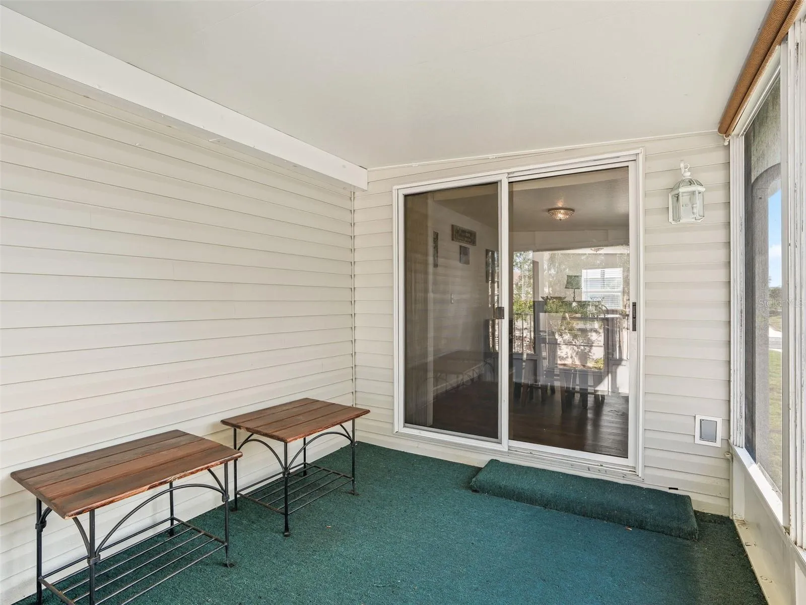 Opposite view of SCREEN ENCLOSED LANAI - Shows SLIDING GLASS DOORS leading to BONUS ROOM/ FLEX SPACE.