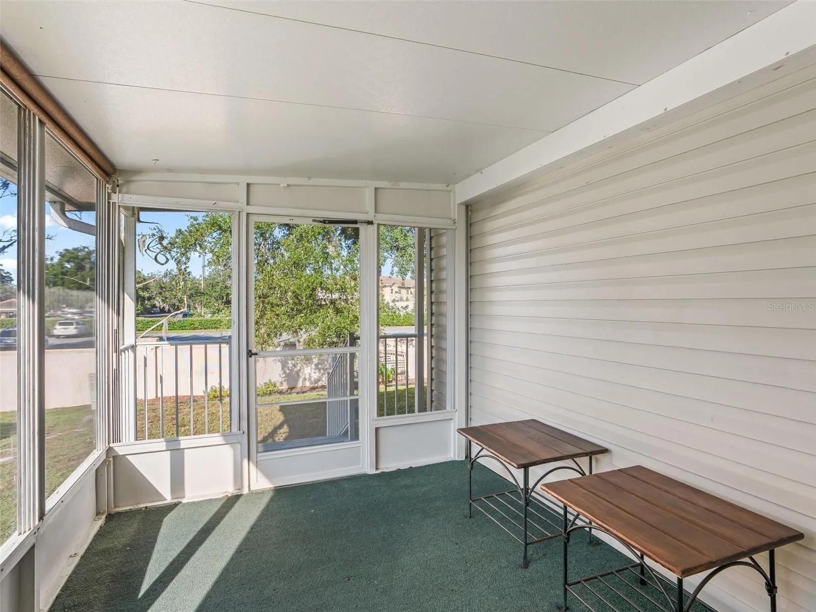 View of SCREEN ENCLOSED LANAI in rear of home. Note REAR PRIVACY due to CBS privacy wall.