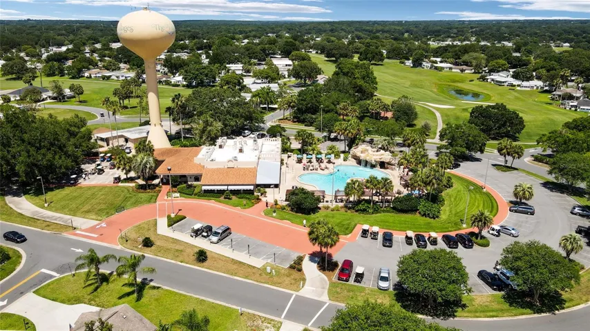 View of the VILLAGES WATER TOWER next to the ORANGE BLOSSOM HILLS COUNTRY CLUB - Restaurant is shown on L center and resort style pool with waterfalls on R. WATER TOWER CIRCLE surrounds this haven on the hilltop.