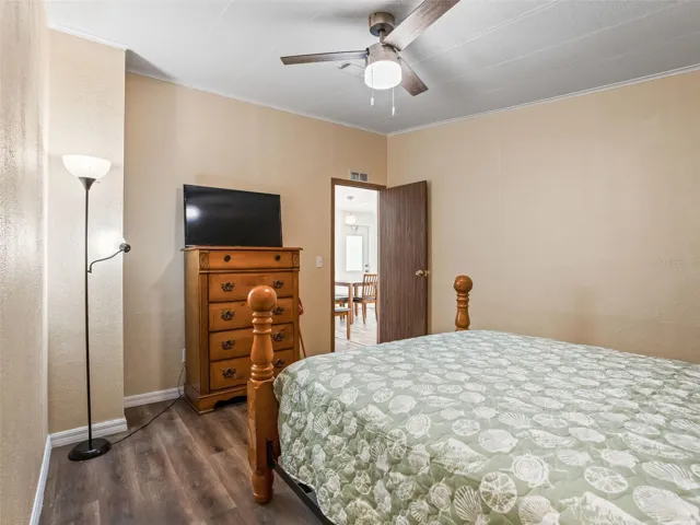 View of BEDROOM #2 from back corner - Shows DOORWAY leading to HALLWAY &amp; MAIN LIVING AREA.