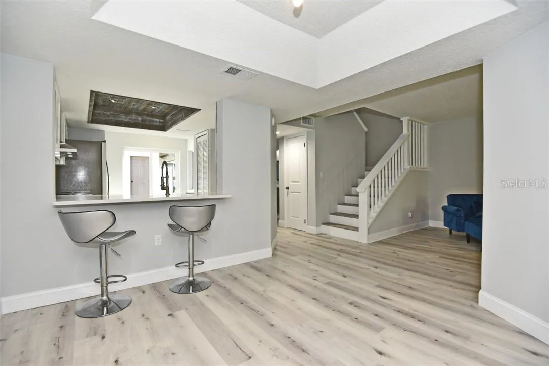 View from the dining room to the kitchen, foyer with storage room under the stairway.
