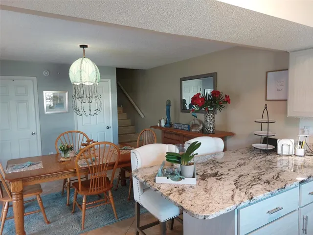 Staged photo of kitchen and dining.