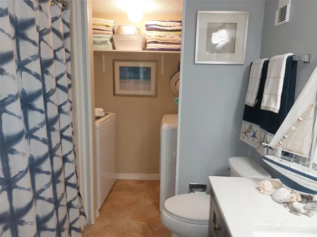 Downstairs full bathroom and laundry area.