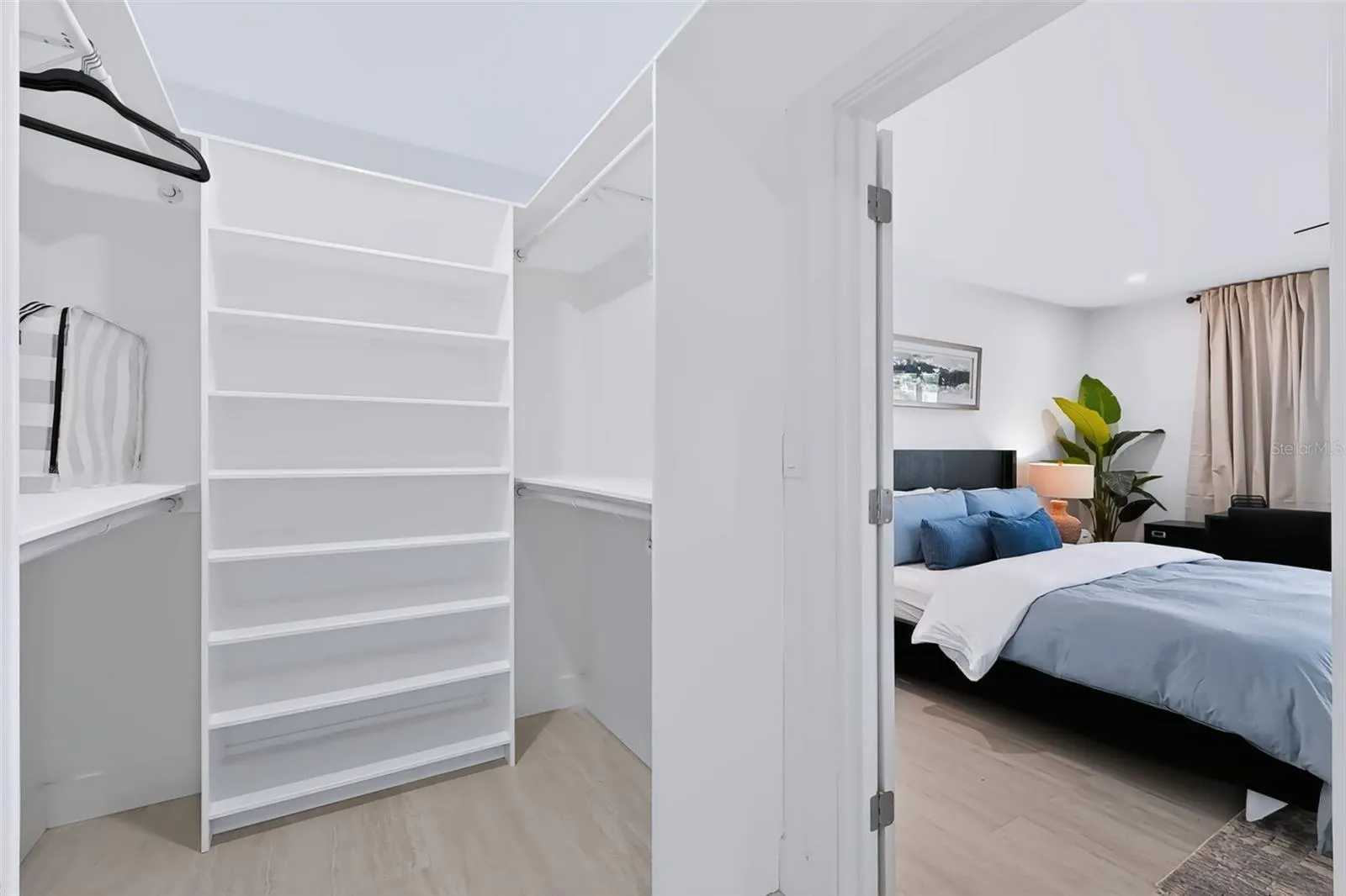 1 of 2 walk in closets - primary bedroom