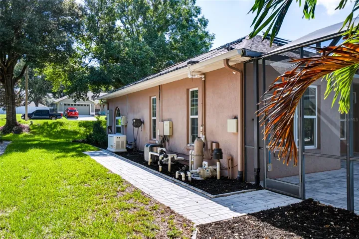 Side of home showing Generac and pool equipment