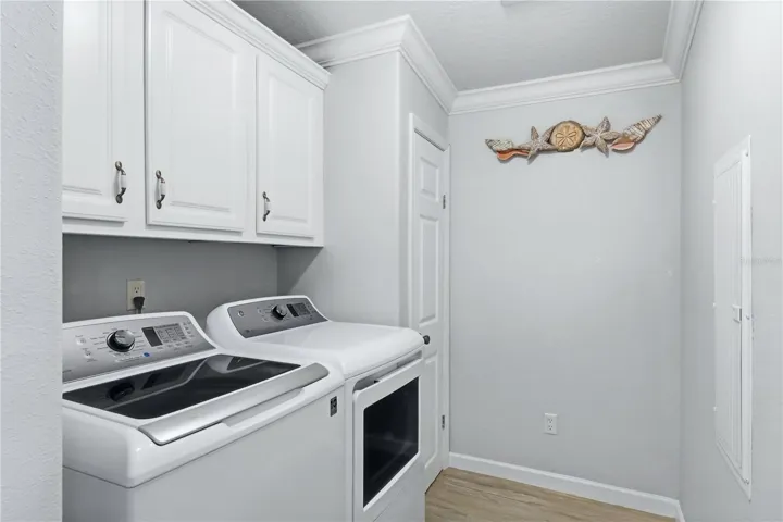 Inside Laundry Room w cabinets & storage