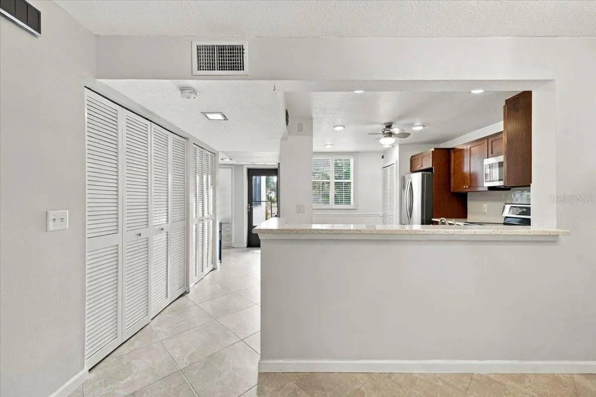 Hallway into unit with two closets