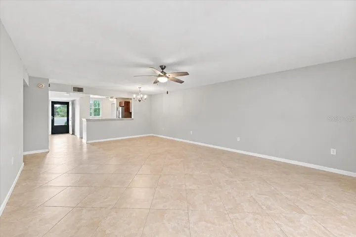 Dining and living room area looking toward kitchen and front door