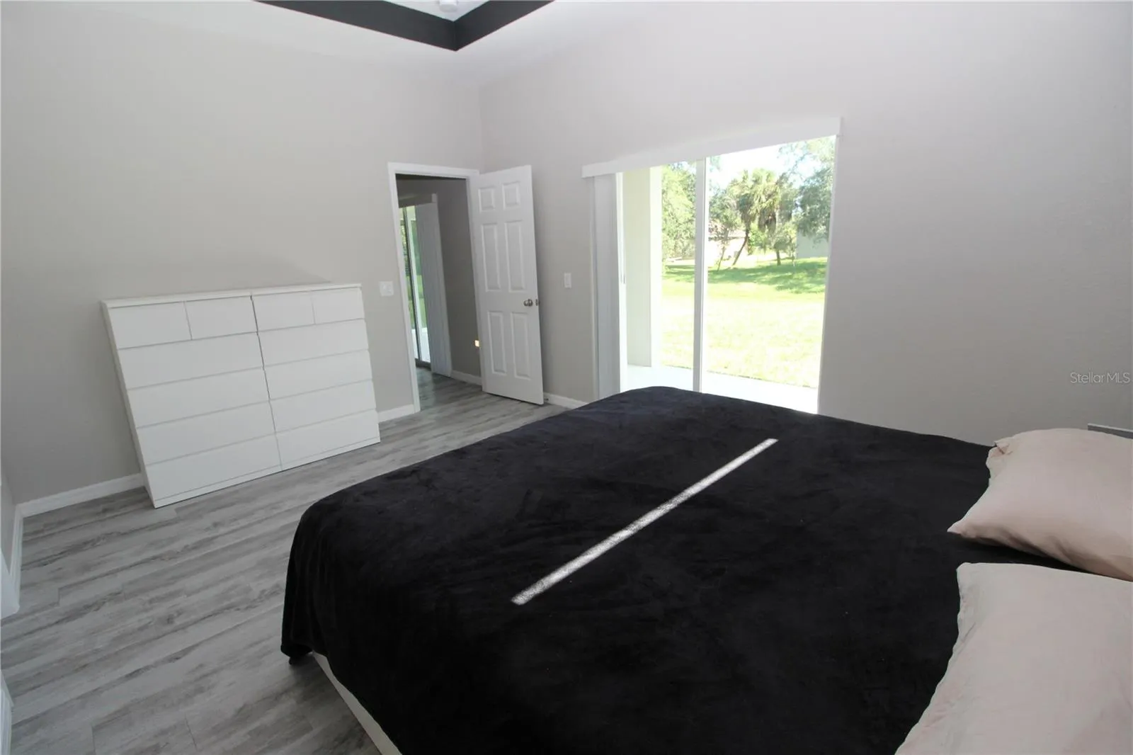 Primary Bedroom with sliding glass doors out to your private/covered lanai...