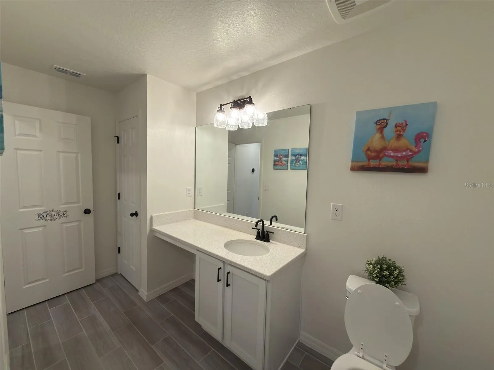 Guest Bathroom facing linen closet and vanity