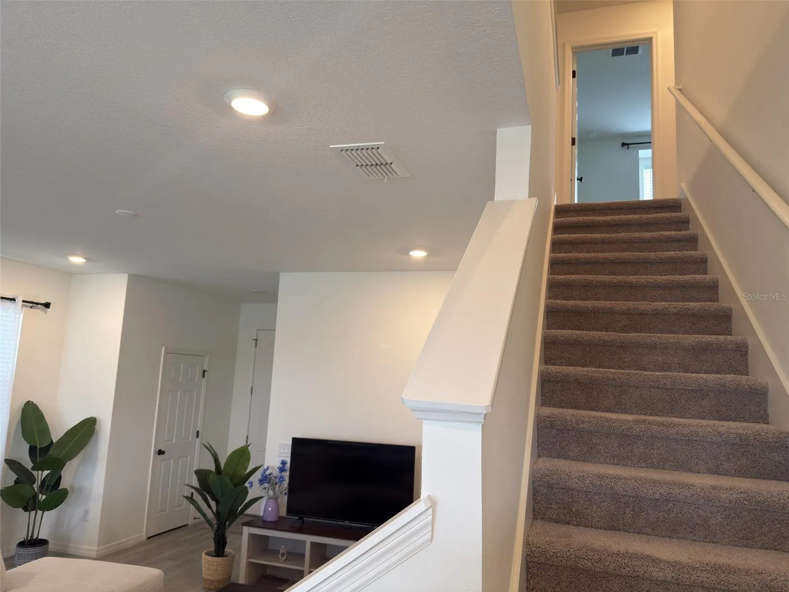 Stairs leading to 3 bedrooms, 2 bathrooms and family room