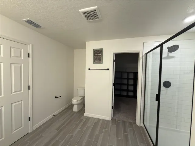Primary bathroom facing walk in closet