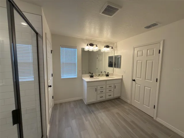 Primary bathroom facing vanity