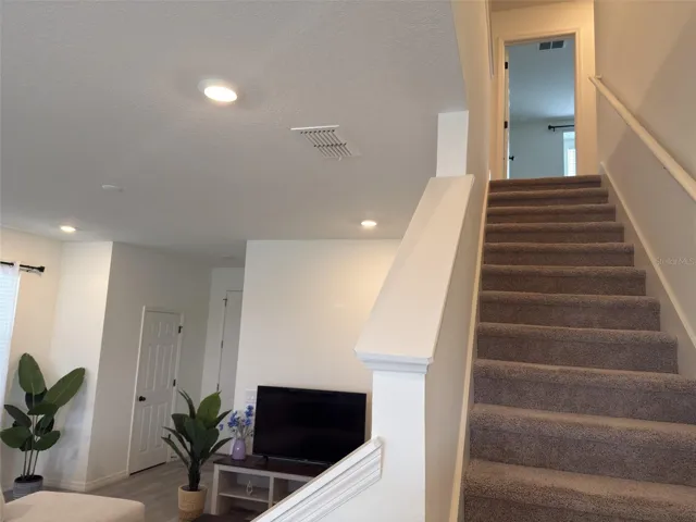 Stairs leading to 3 bedrooms, 2 bathrooms and family room