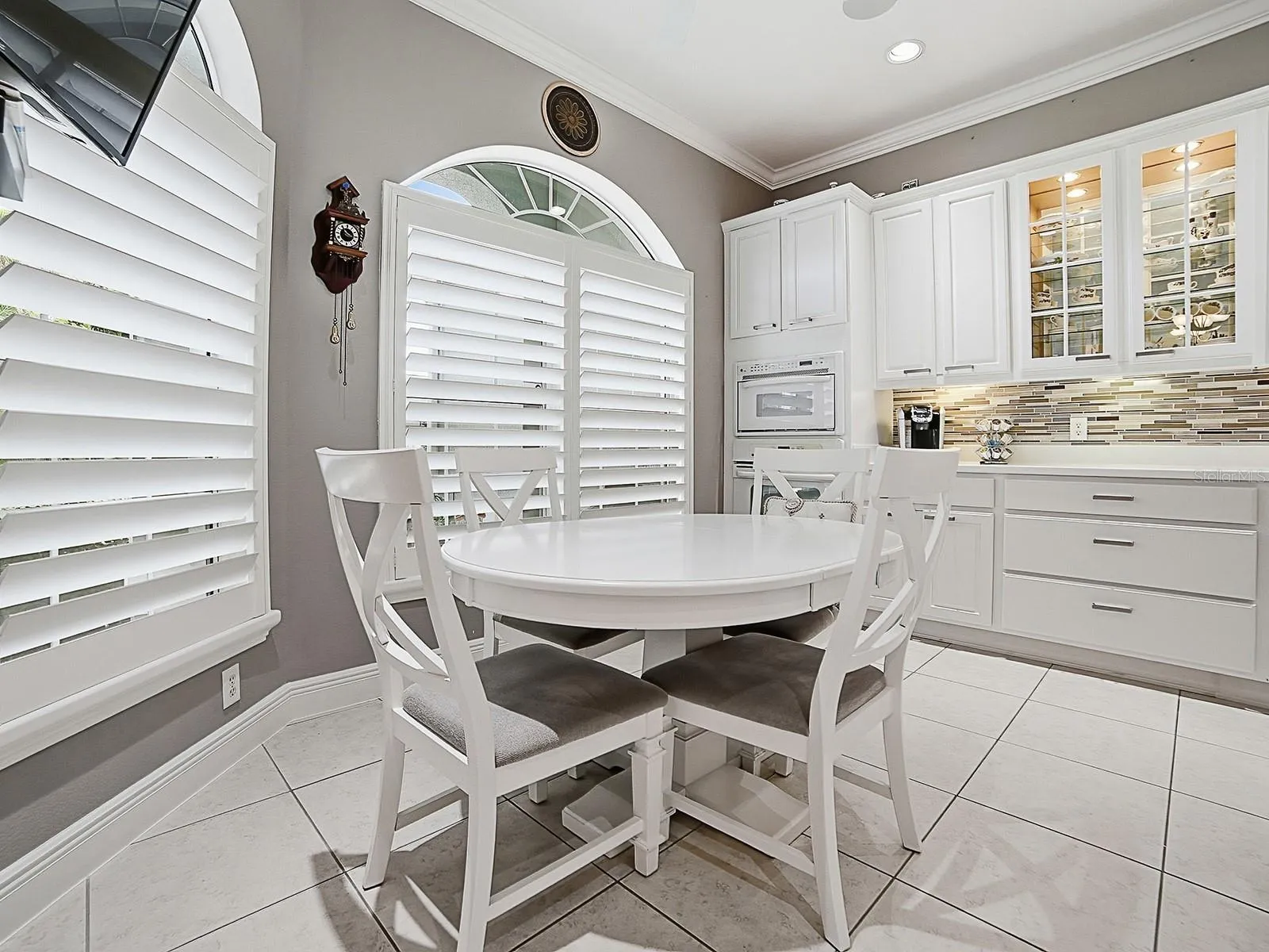 YOU'LL LOVE ALL THE COUNTER SPACE AND STORAGE, WALL OVENS, POT DRAWERS, GLASS INSERTS IN CABINETS, TILED BACKSPLASH, AND UNDER COUNTER LIGHTING.