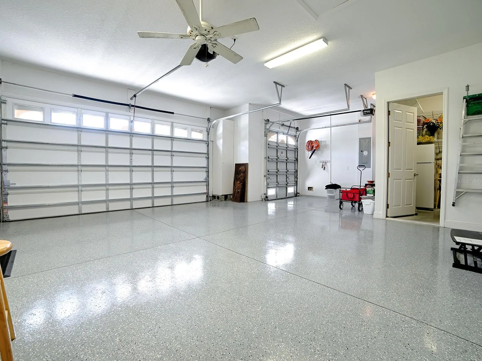 PLENTY OF ROOM IN THIS 824 SQ. FT. GARAGE WITH EPOXY FLOORING, AND A CUSTOM AIR CONDITIONED STORAGE ROOM.