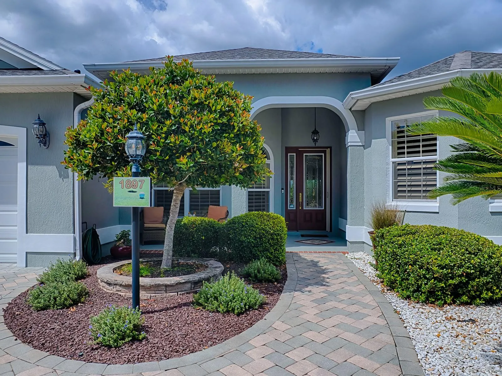 LOVELY ENTRANCE WITH A FRONT PORCH AND LEADED GLASS FRONT DOOR WITH SIDELITE.